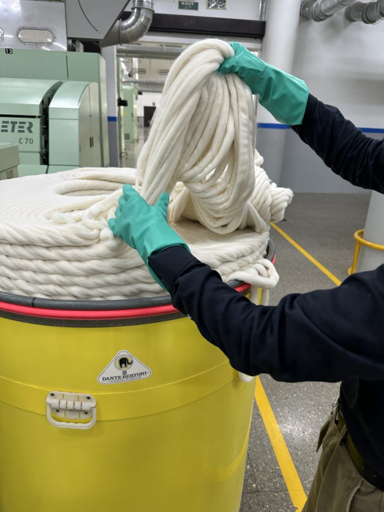 cotton fibers being handled during textile production process